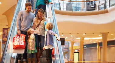 Family on a Escalator in the Shopping Mall 